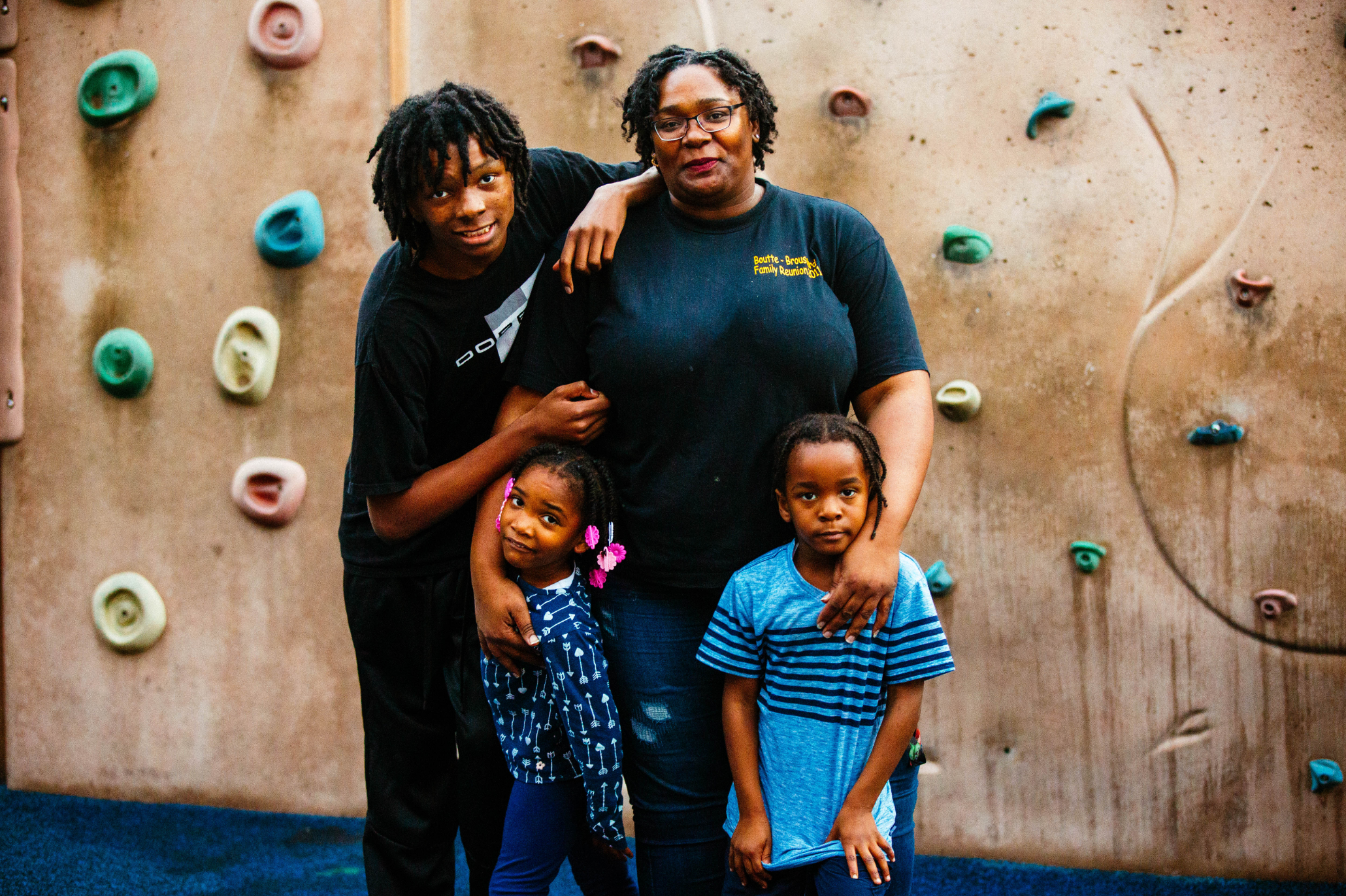 Denise Wilson with her children photographed at Hemmingway Park in Compton on December 5th, 2019. (Chava Sanchez/LAist)